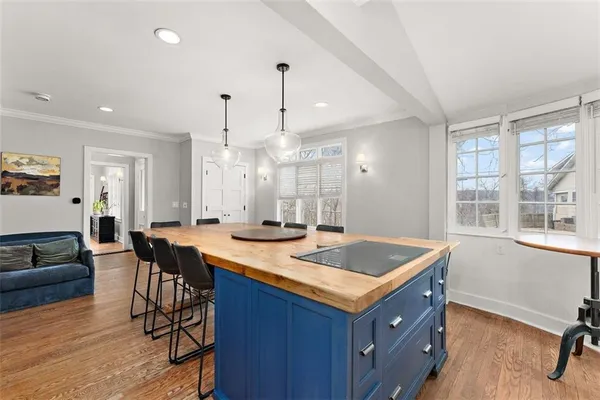 a kitchen with a stove a sink a dining table and chairs