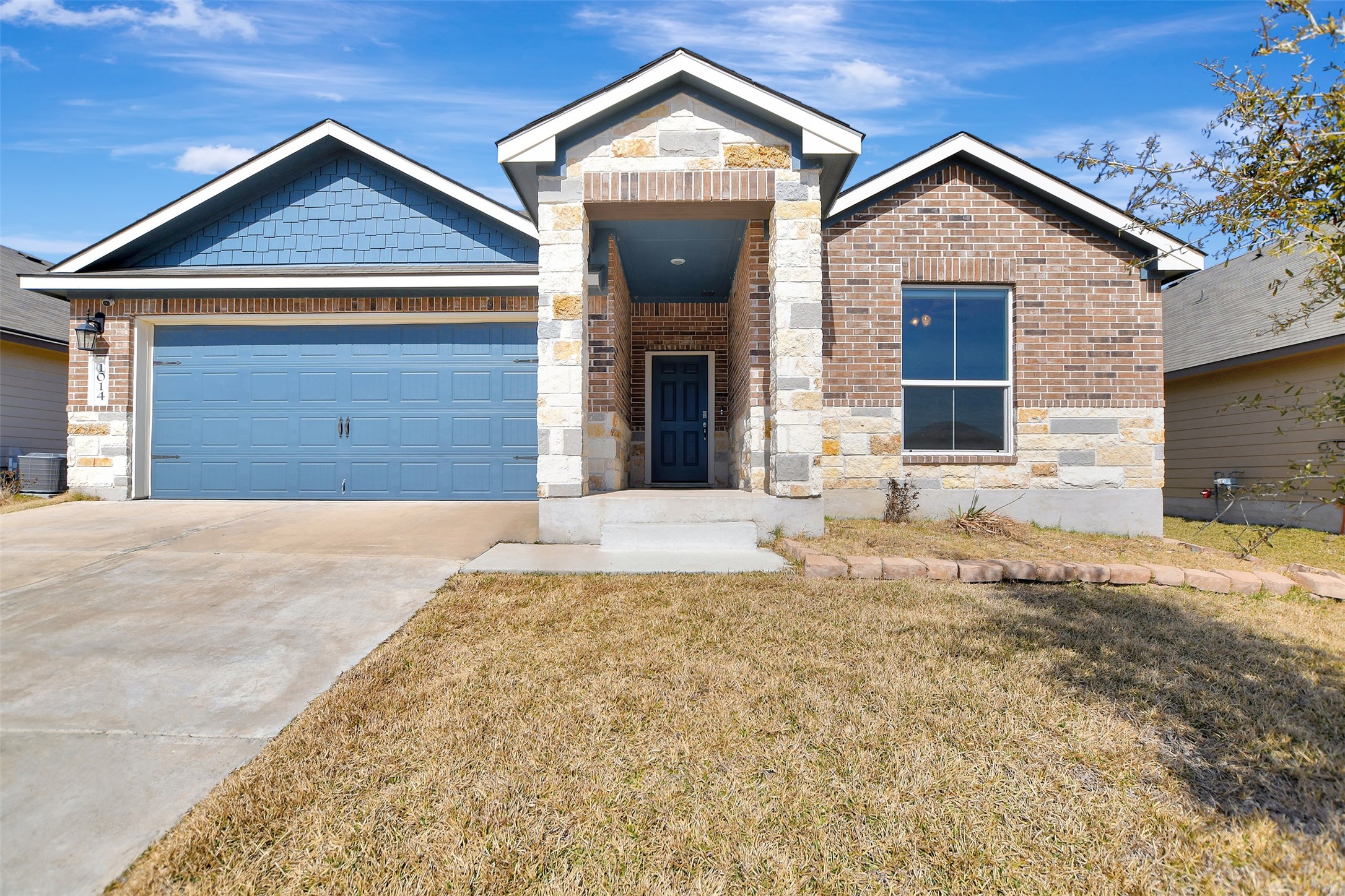 1014 Fannin Street Brenham, TX 77833 - Photo 1 of 43 a front view of a house with a yard and garage