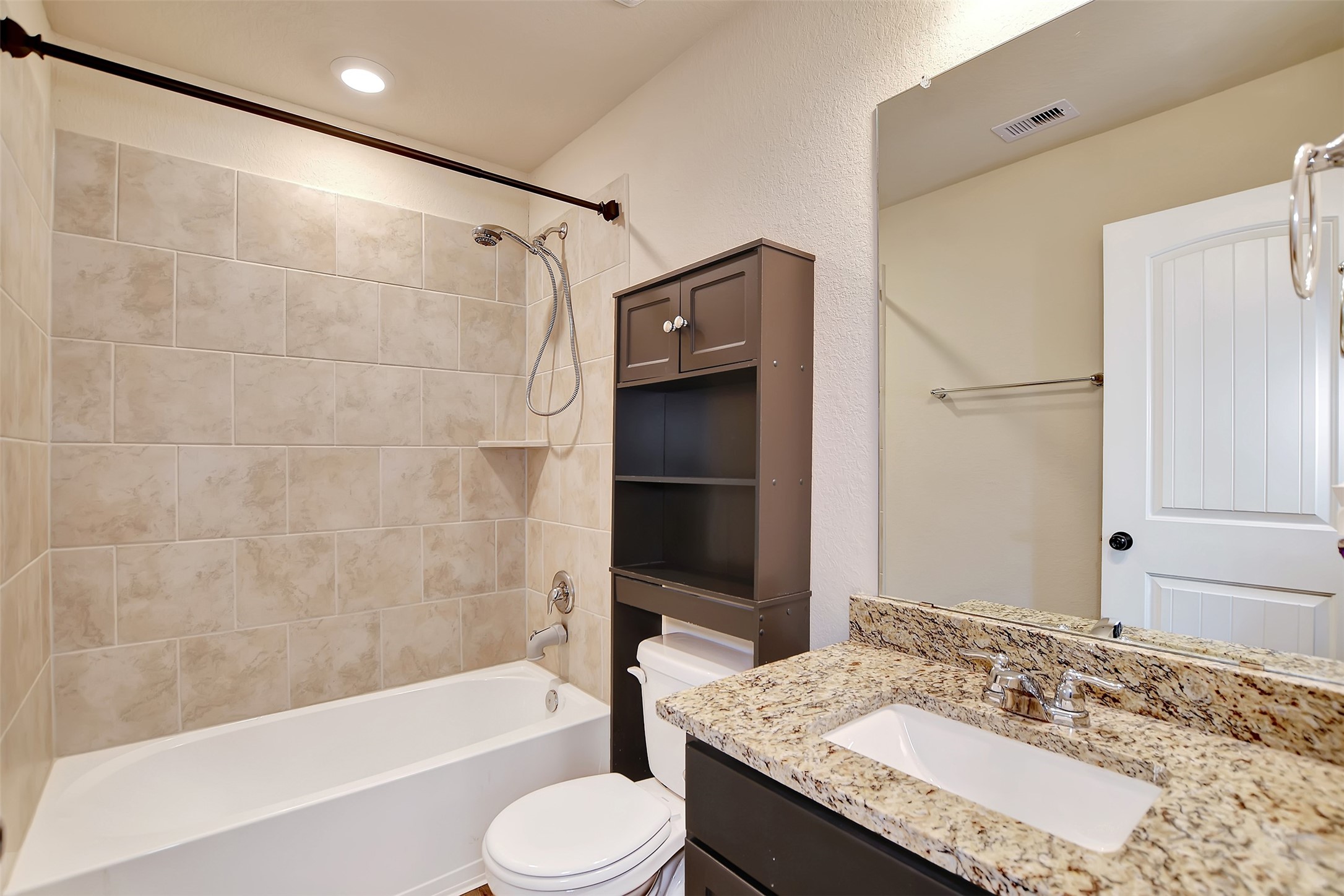 1014 Fannin Street Brenham, TX 77833 - Photo 33 of 43 a bathroom with a granite countertop sink toilet and shower