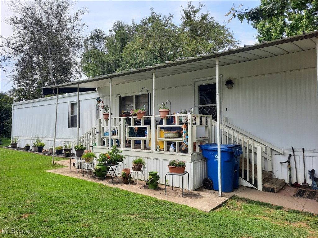 Back of house featuring a patio area and a lawn