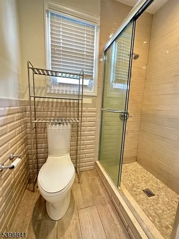 a bathroom with a toilet and a shower