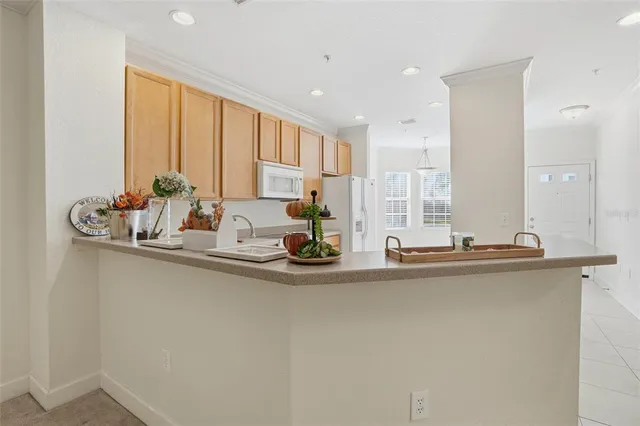 a kitchen with appliances a sink and cabinets
