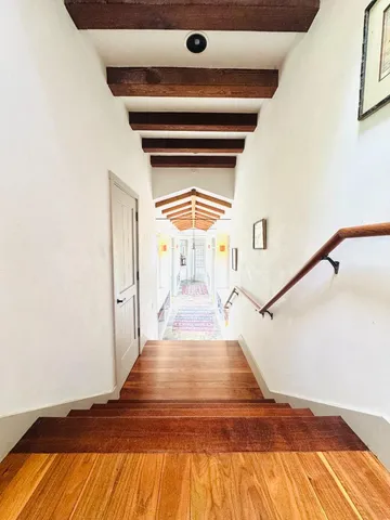 a view of entryway and hall with wooden floor