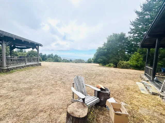 a backyard of a house with table and chairs