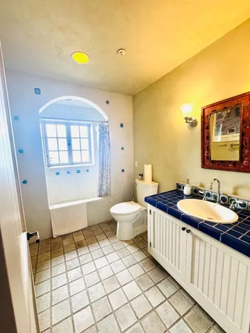 a bathroom with a sink a toilet and a bathtub