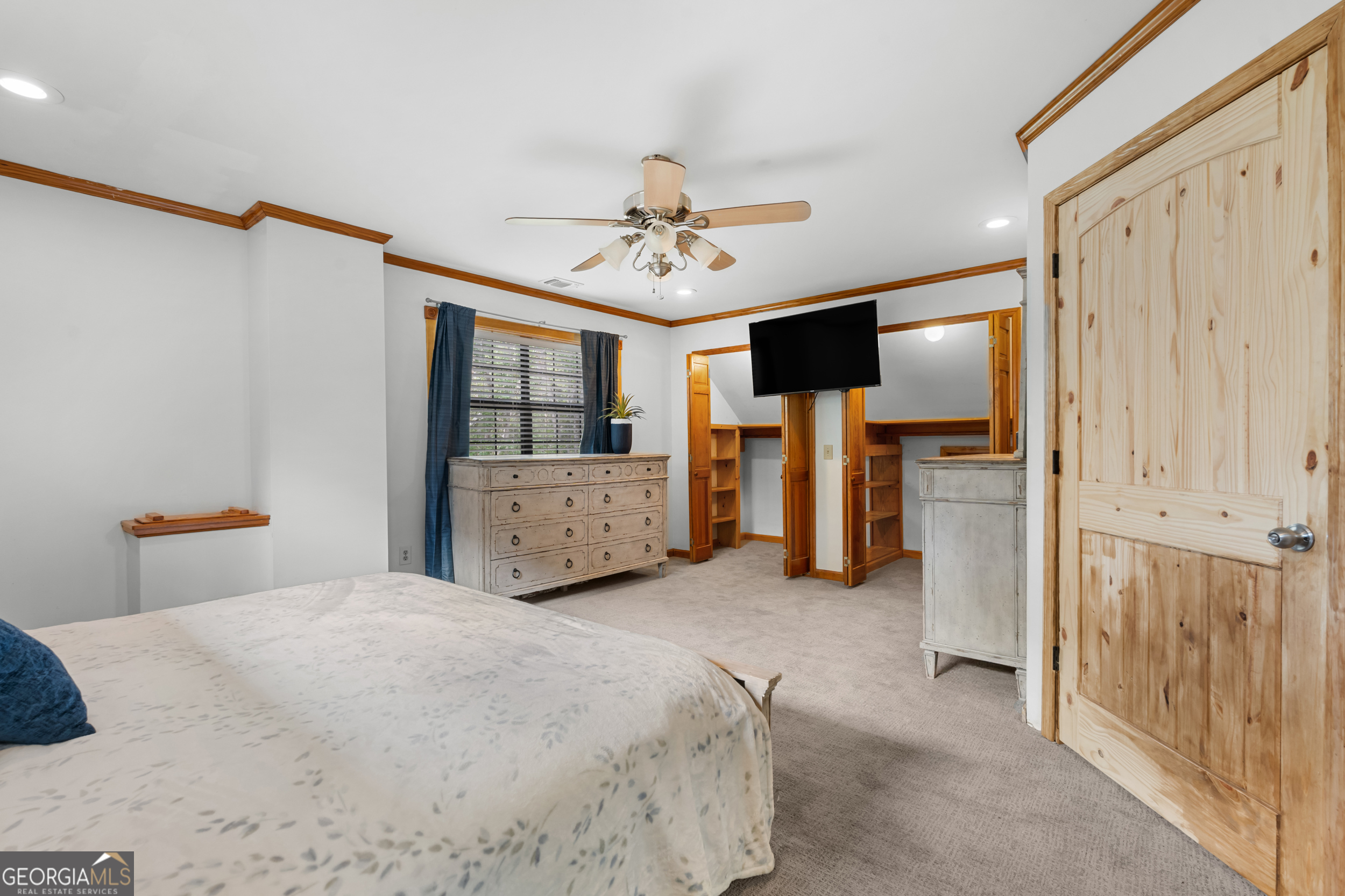 3770 Hill Road Metter, GA 30439 - Photo 13 of 32 a spacious bedroom with a bed and a chandelier