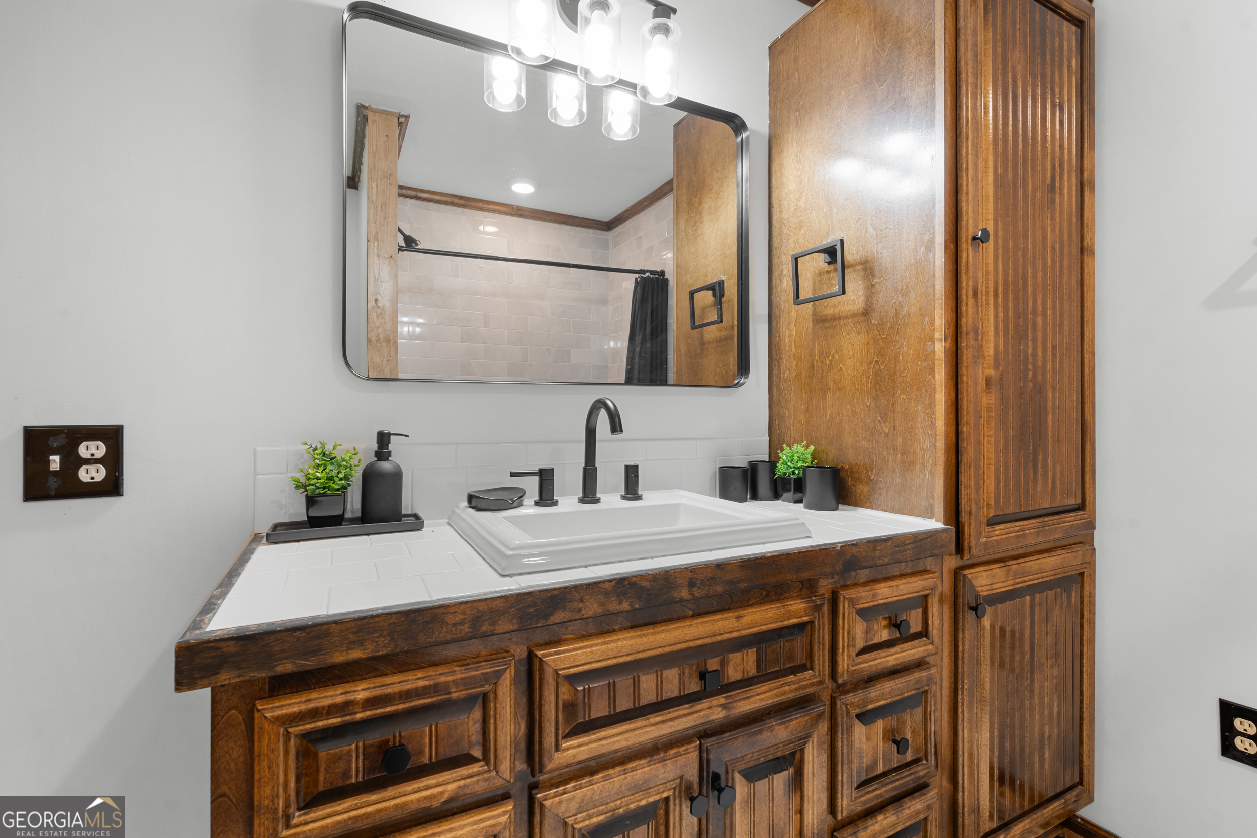 3770 Hill Road Metter, GA 30439 - Photo 14 of 32 a bathroom with a sink and a mirror