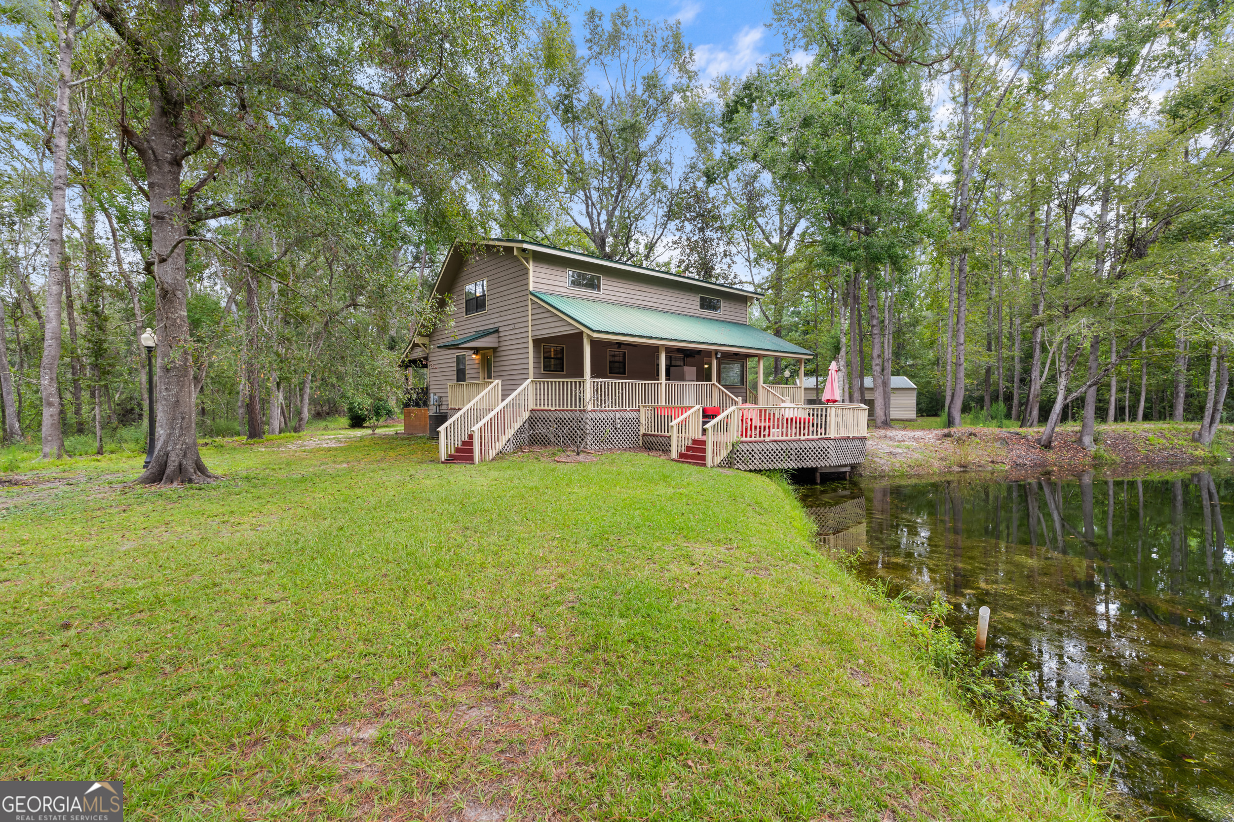 3770 Hill Road Metter, GA 30439 - Photo 22 of 32 a view of a house with a yard porch and sitting area
