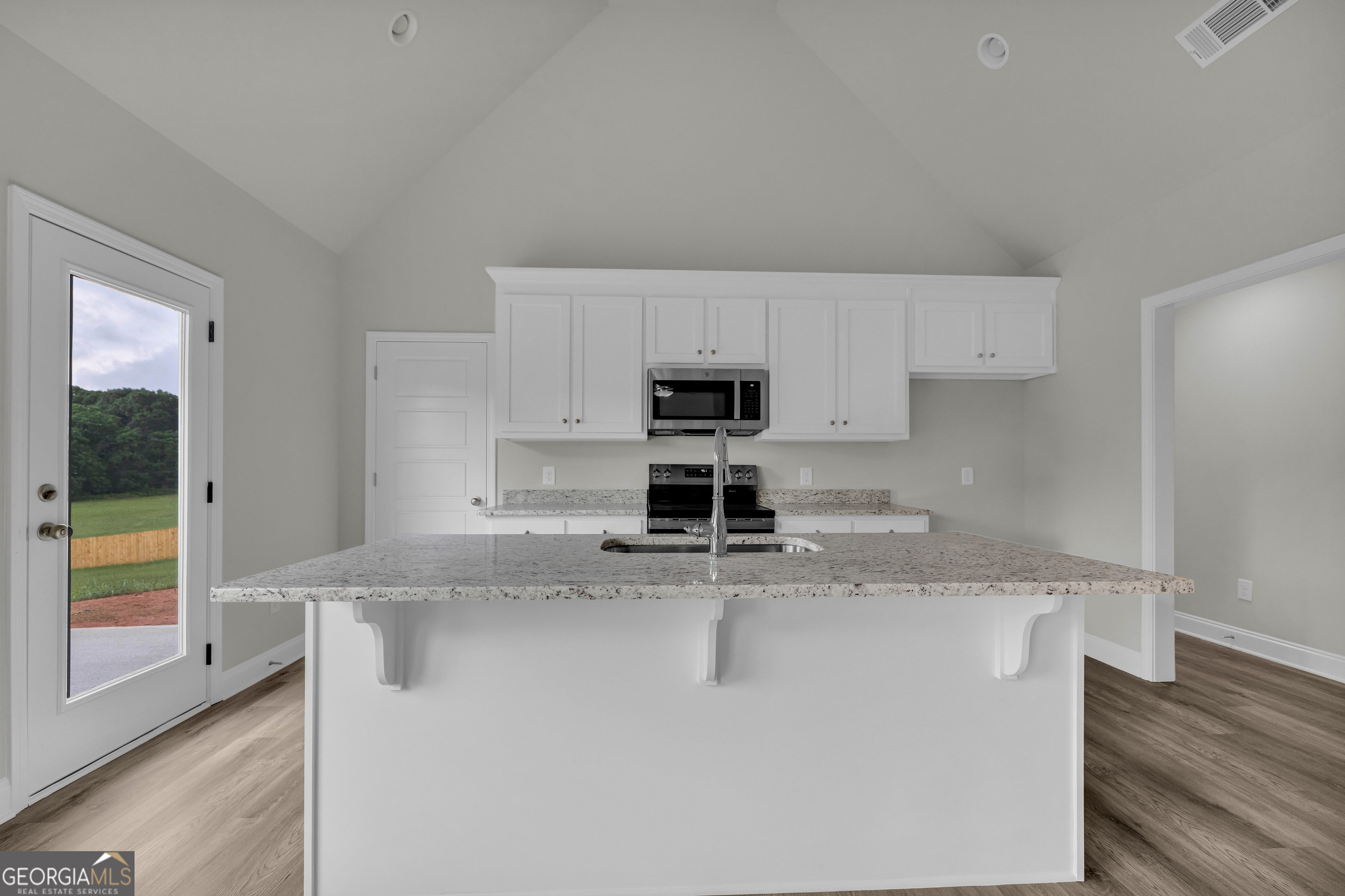 110 Sewell Road Lavonia, GA 30553 - Photo 34 of 73 a kitchen with stainless steel appliances granite countertop a sink a stove and a refrigerator