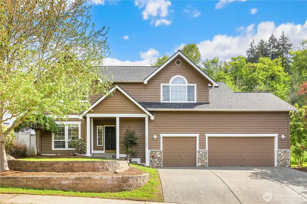 a front view of a house with a yard and garage