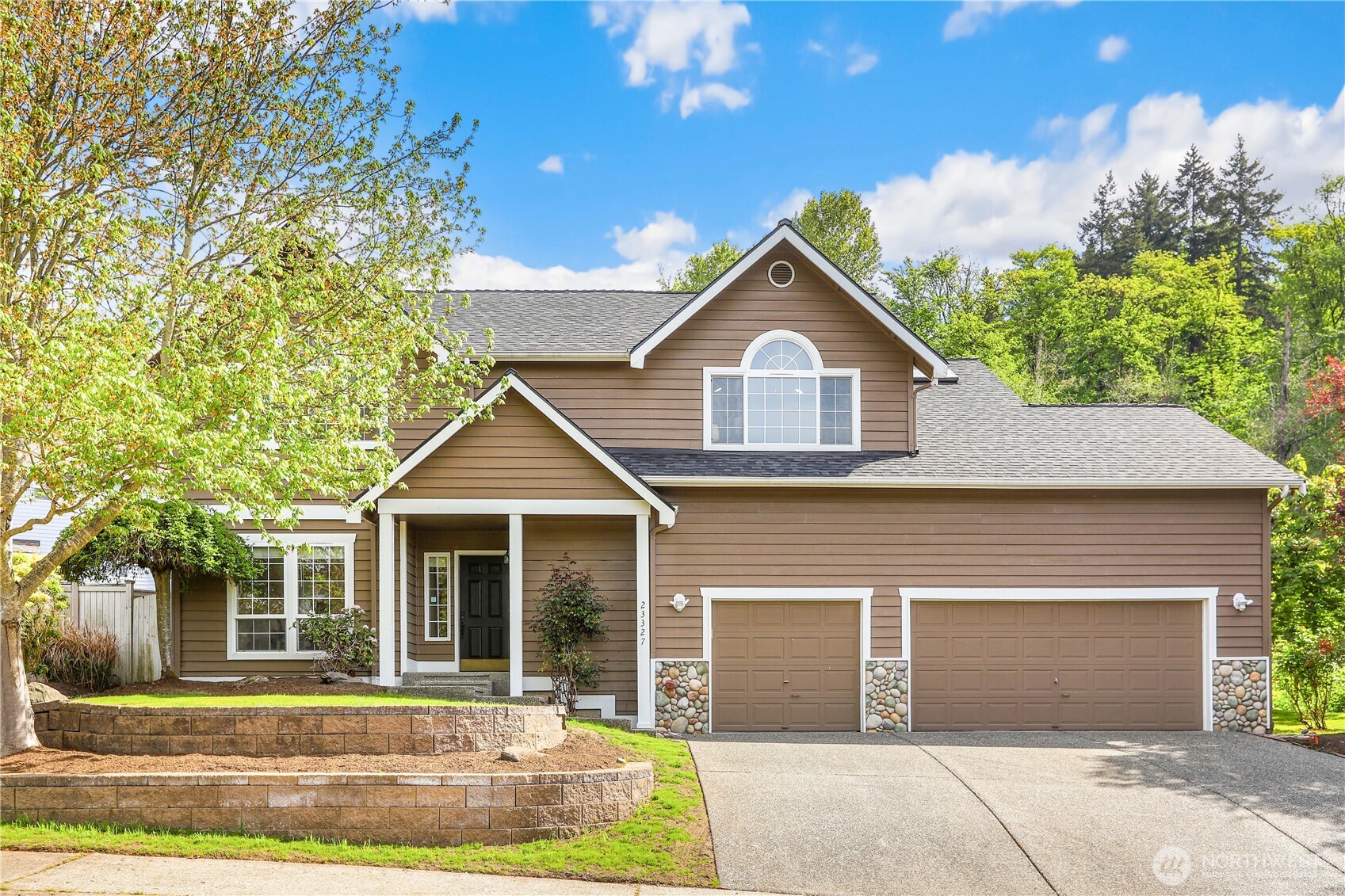 a front view of a house with a yard and garage