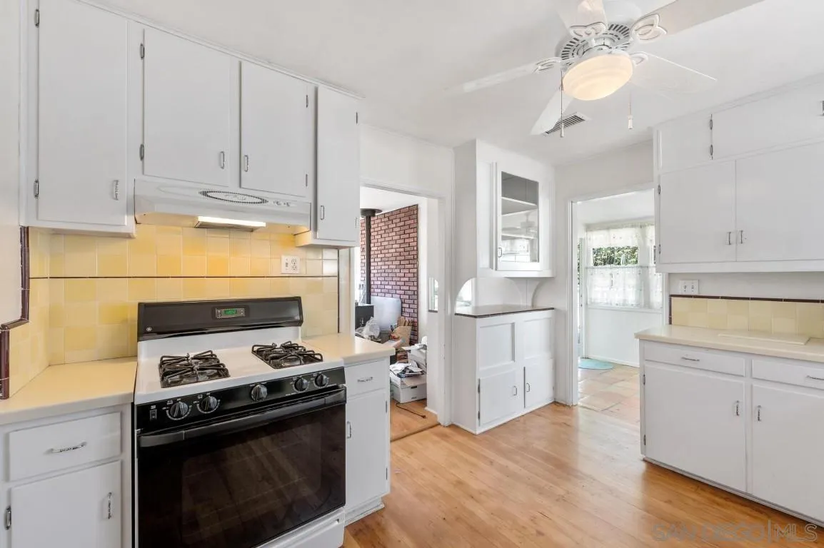 155 Willowside Terrace Alpine, CA 91901 - Photo 13 of 38 a kitchen with a stove and white cabinets