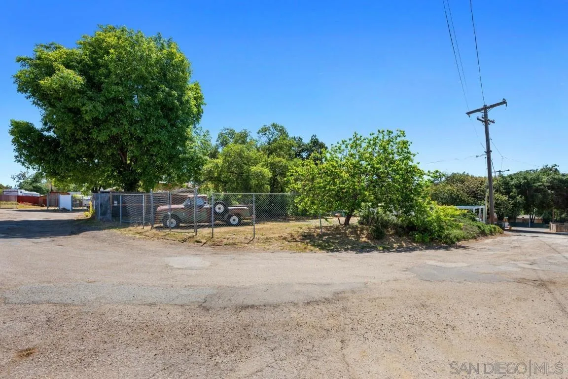 155 Willowside Terrace Alpine, CA 91901 - Photo 32 of 38 a view of backyard with a table and chairs under an umbrella