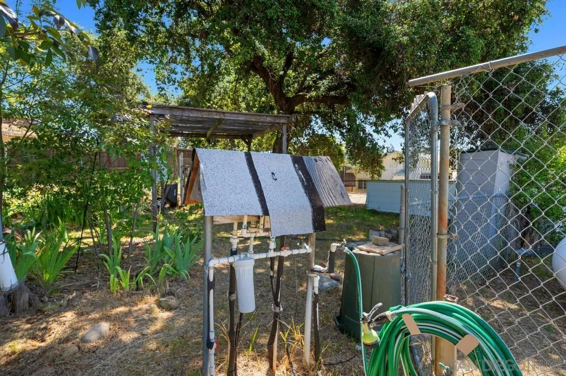 155 Willowside Terrace Alpine, CA 91901 - Photo 38 of 38 a view of a patio with table and chairs potted plants with wooden floor and fence