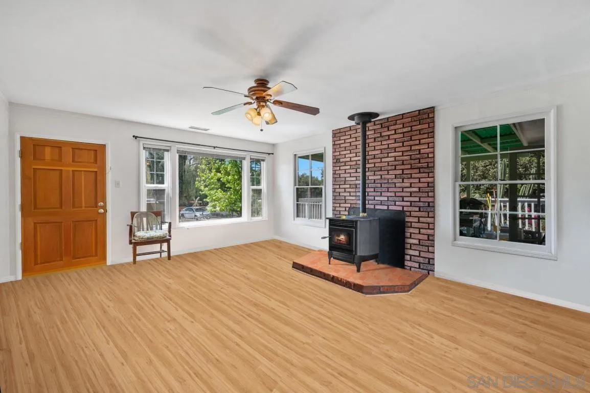 155 Willowside Terrace Alpine, CA 91901 - Photo 8 of 38 a view of an empty room with a window and wooden floor