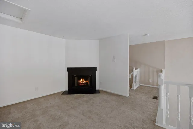 a view of an empty room with a fireplace