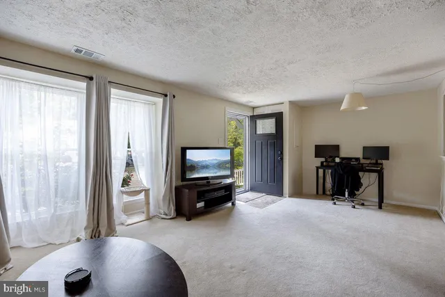 a view of a livingroom with furniture and a flat screen tv