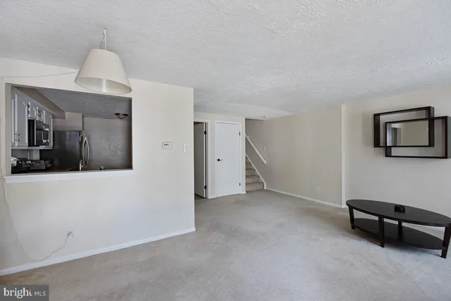 a view of a livingroom with furniture and a ceiling fan