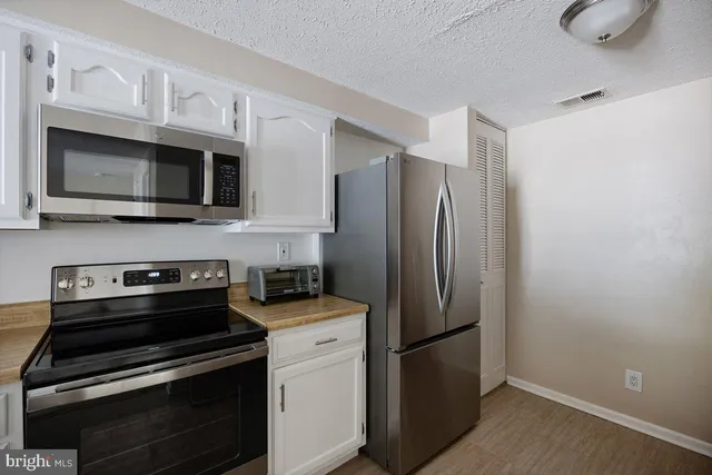 a kitchen with a sink stove and microwave