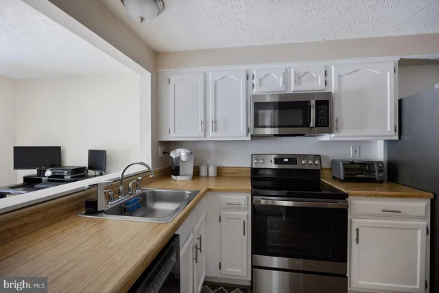 a bathroom with a sink mirror and toilet
