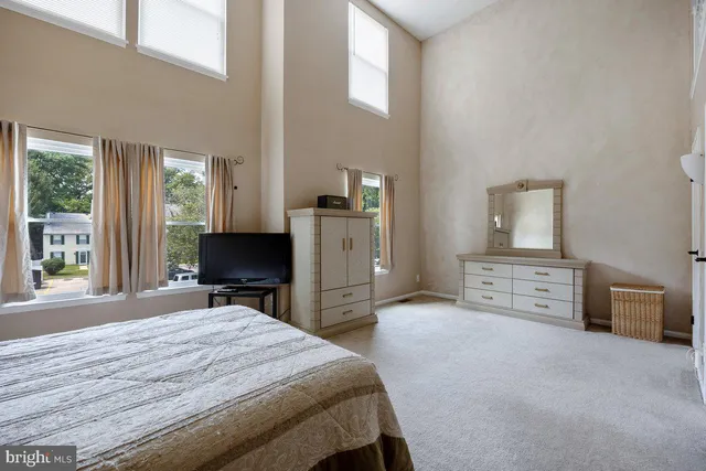 a spacious bedroom with a bed and a window