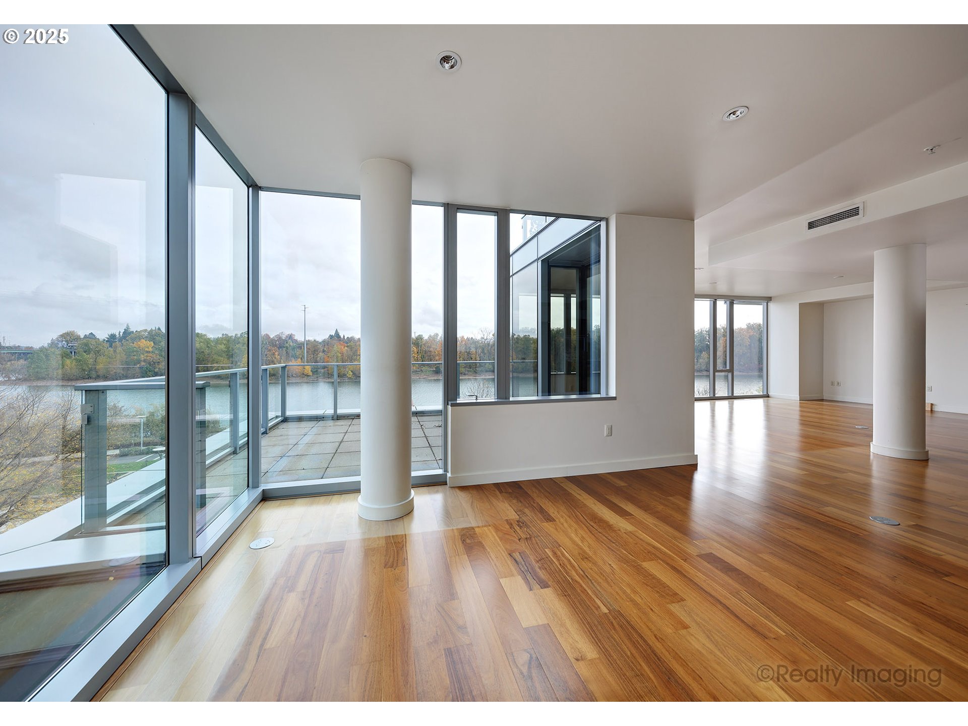 841 Southwest Gaines Street, Unit 319 Portland, OR 97239 - Photo 11 of 44 wooden floor in an empty room with a window