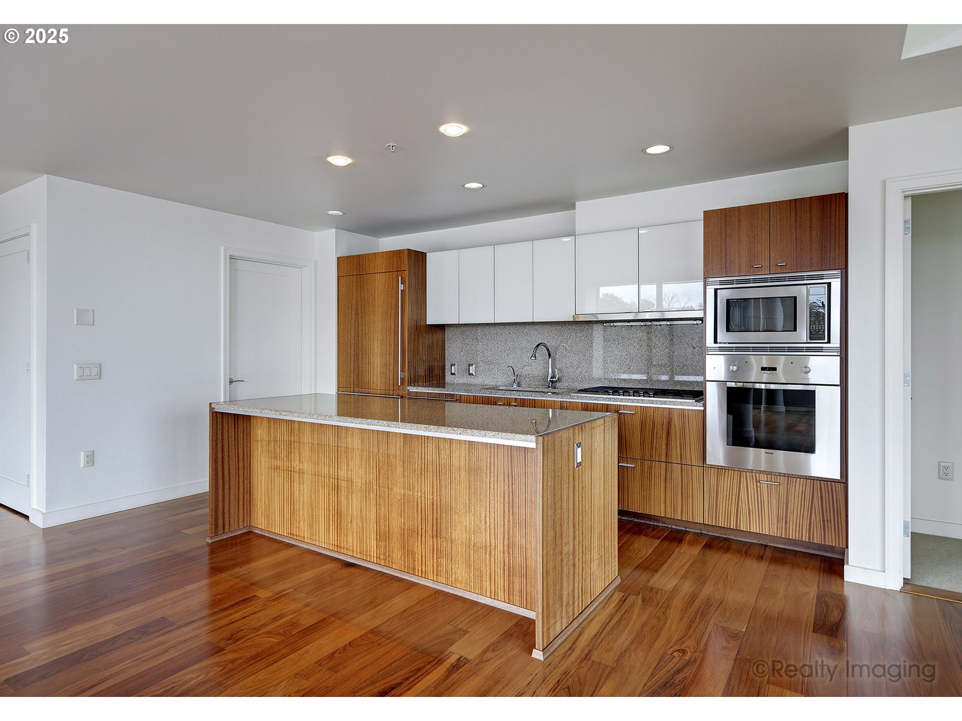 841 Southwest Gaines Street, Unit 319 Portland, OR 97239 - Photo 14 of 44 a kitchen with stainless steel appliances granite countertop a stove a sink and a refrigerator