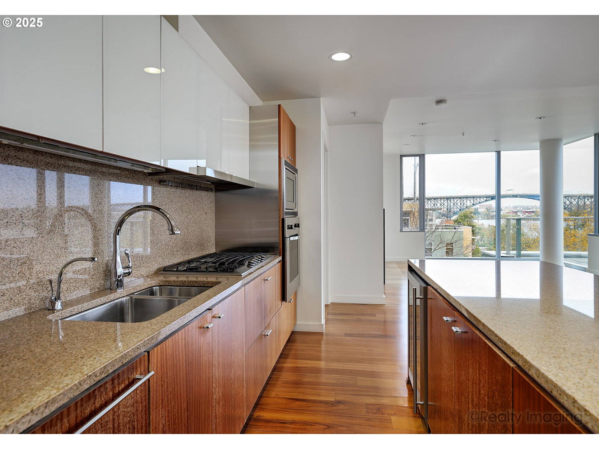 841 Southwest Gaines Street, Unit 319 Portland, OR 97239 - Photo 15 of 44 a kitchen with stainless steel appliances granite countertop a sink a stove and a wooden floors