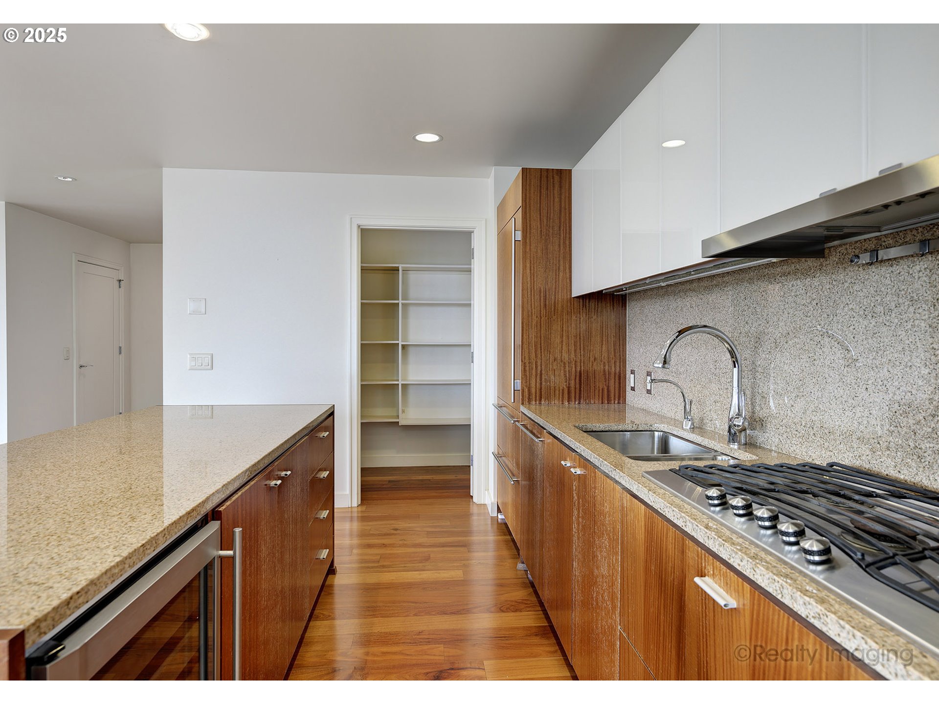 841 Southwest Gaines Street, Unit 319 Portland, OR 97239 - Photo 16 of 44 a kitchen with stainless steel appliances granite countertop a sink and cabinets