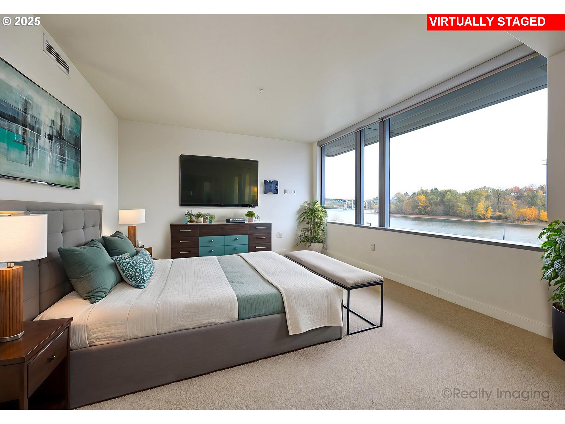 841 Southwest Gaines Street, Unit 319 Portland, OR 97239 - Photo 17 of 44 a bedroom with a large bed and a flat tv screen on dresser