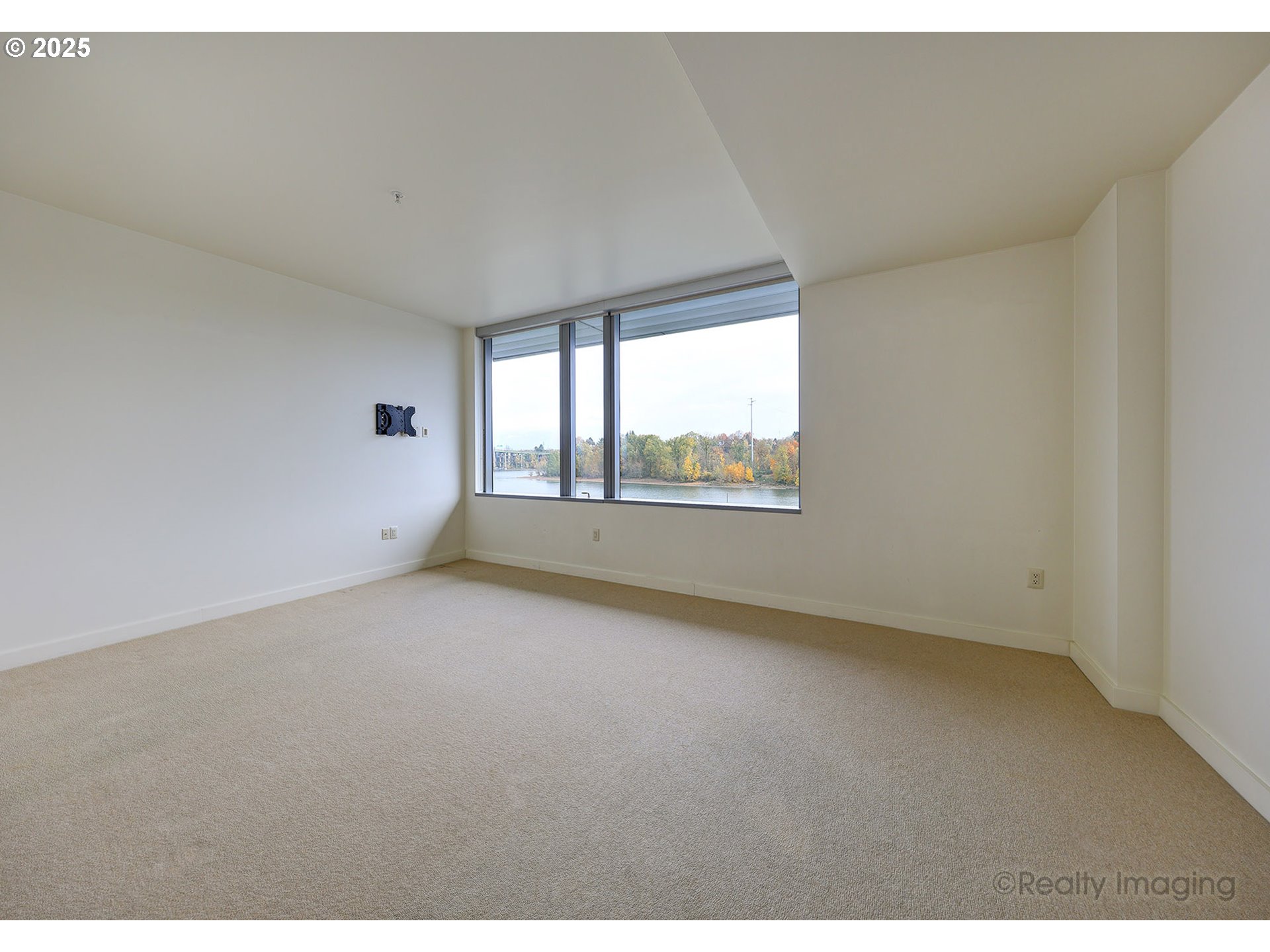 841 Southwest Gaines Street, Unit 319 Portland, OR 97239 - Photo 18 of 44 a view of an empty room with a window