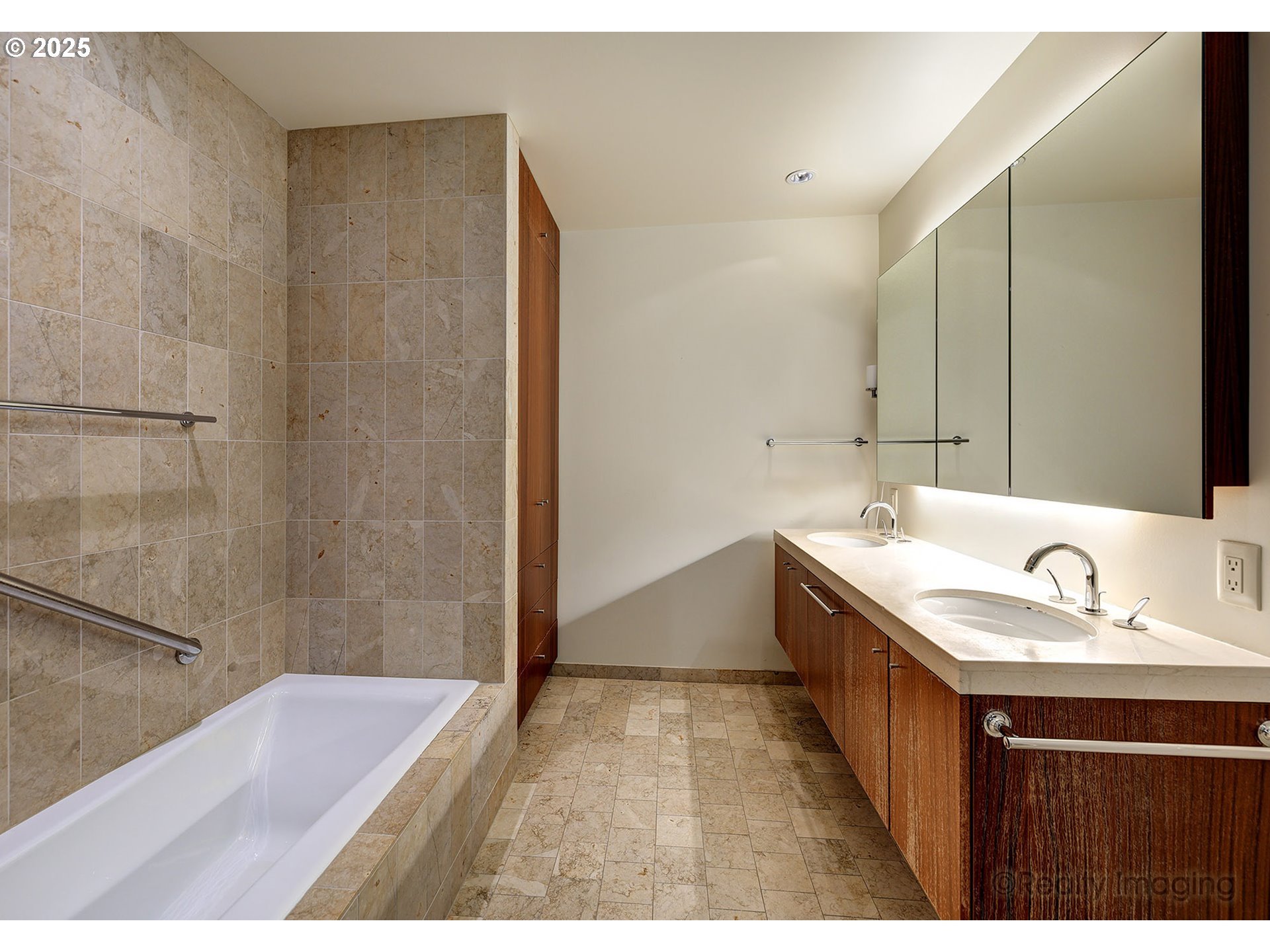 841 Southwest Gaines Street, Unit 319 Portland, OR 97239 - Photo 22 of 44 a bathroom with a tub sink and mirror