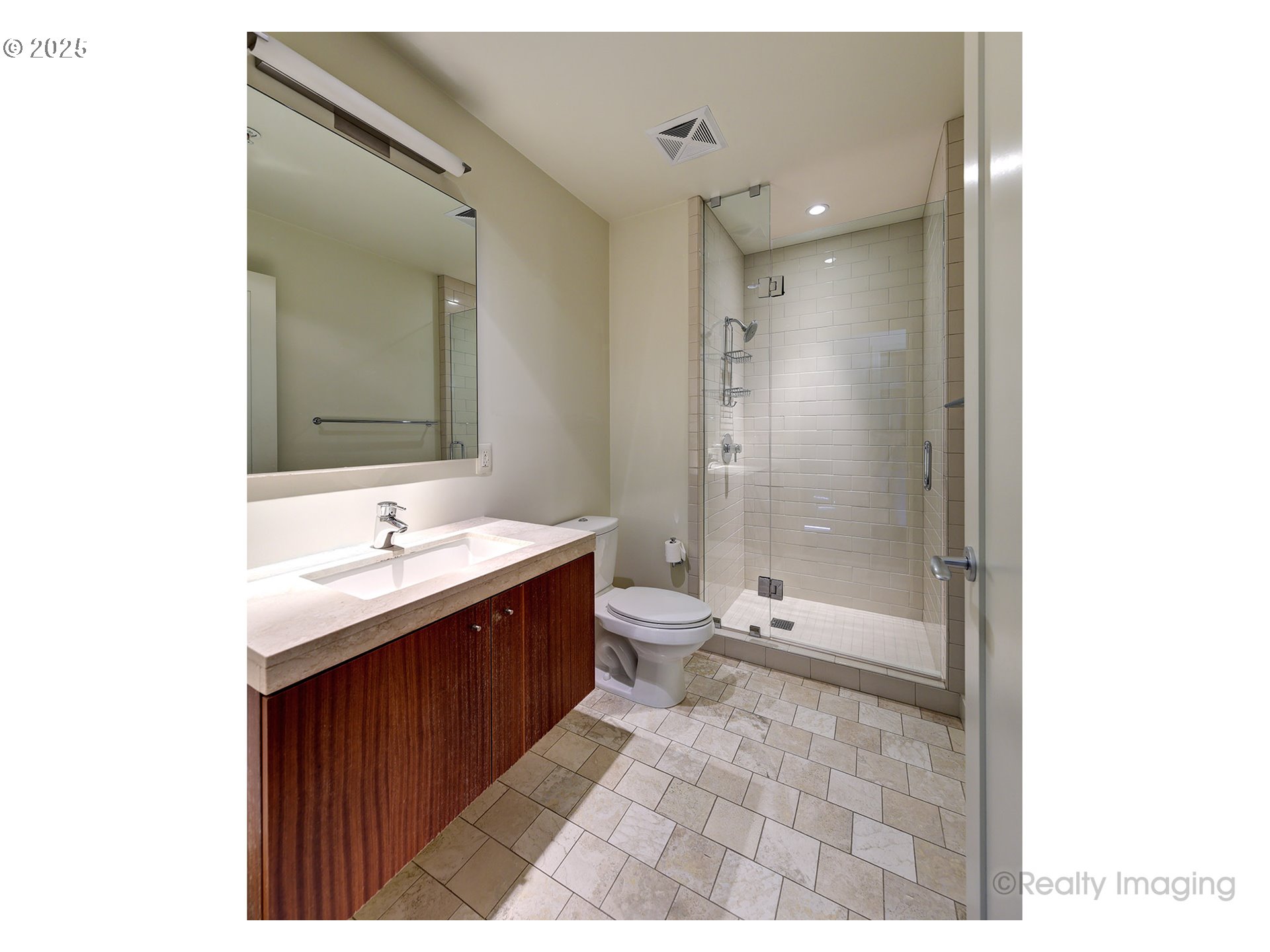 841 Southwest Gaines Street, Unit 319 Portland, OR 97239 - Photo 27 of 44 a bathroom with a sink a toilet and shower