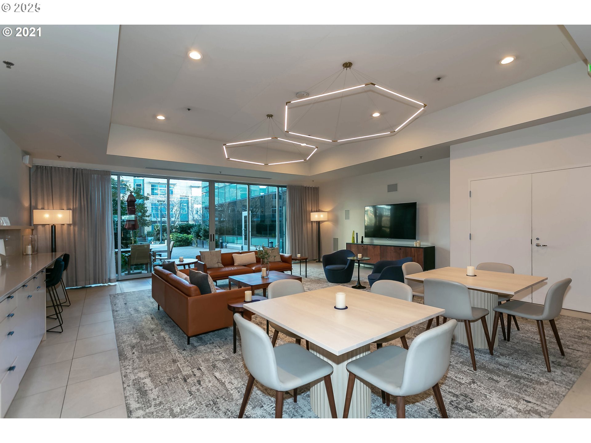 841 Southwest Gaines Street, Unit 319 Portland, OR 97239 - Photo 3 of 44 a living room with furniture a window and a flat screen tv