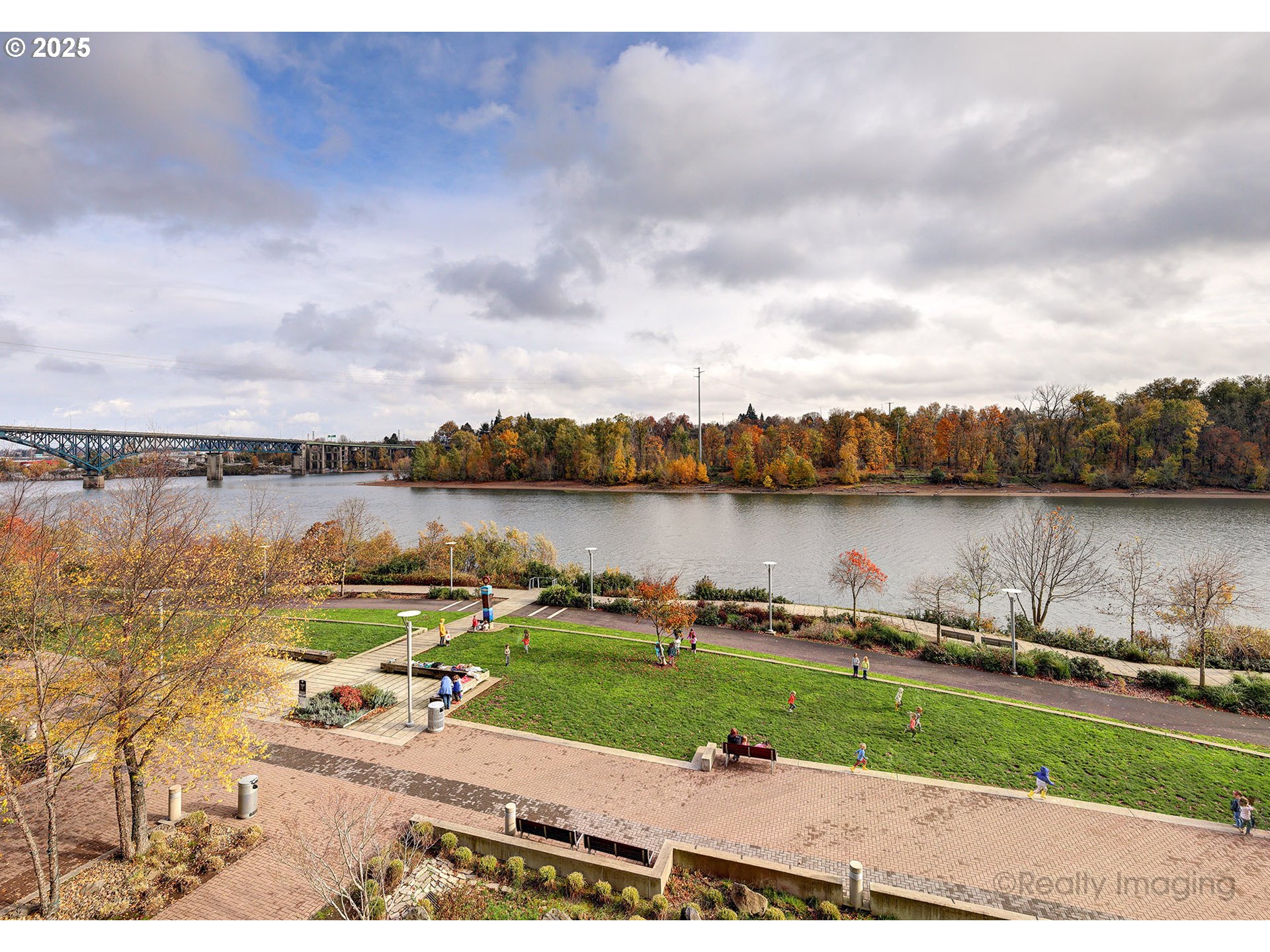 841 Southwest Gaines Street, Unit 319 Portland, OR 97239 - Photo 32 of 44 a view of a lake with houses in the back