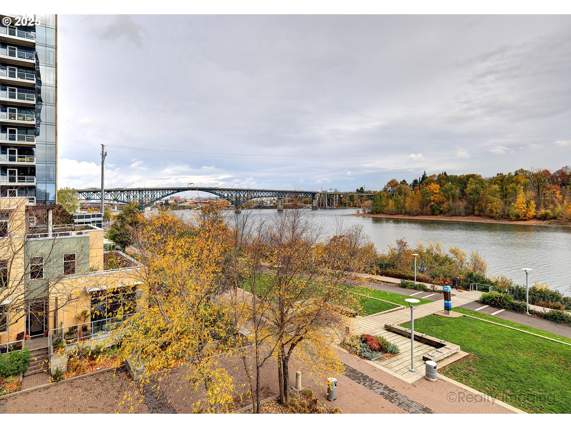 841 Southwest Gaines Street, Unit 319 Portland, OR 97239 - Photo 33 of 44 a view of a lake with houses in back