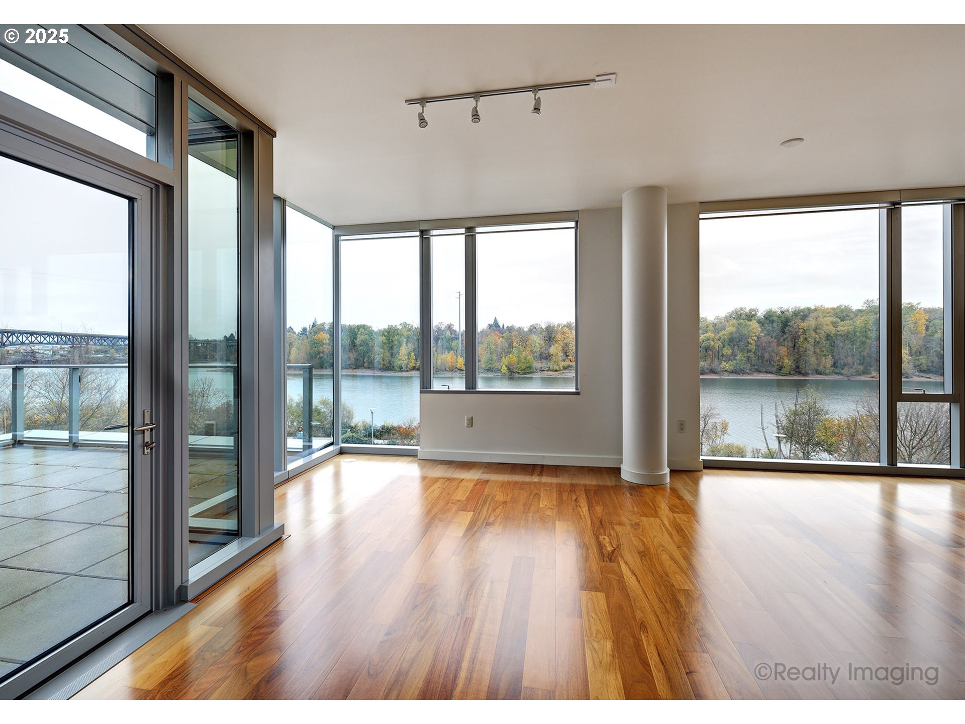 841 Southwest Gaines Street, Unit 319 Portland, OR 97239 - Photo 10 of 44 a view of empty room with wooden floor and fan