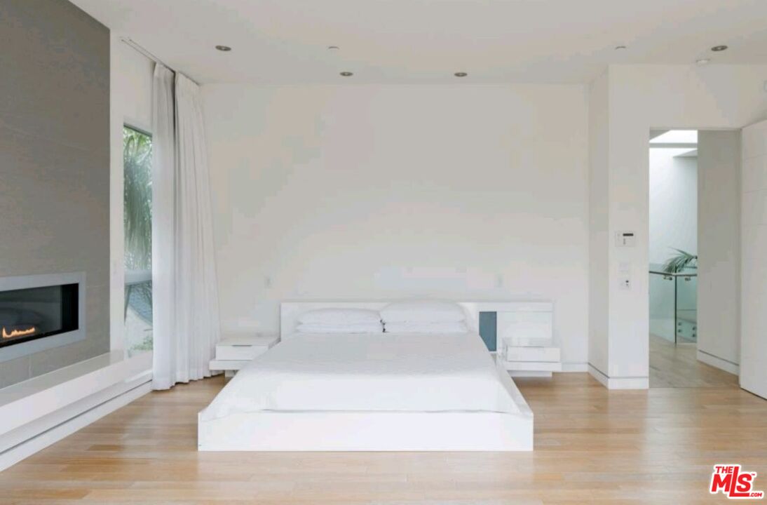 6620 West 5th Street Los Angeles, CA 90048 - Photo 12 of 34 a bedroom with a bed and a fireplace