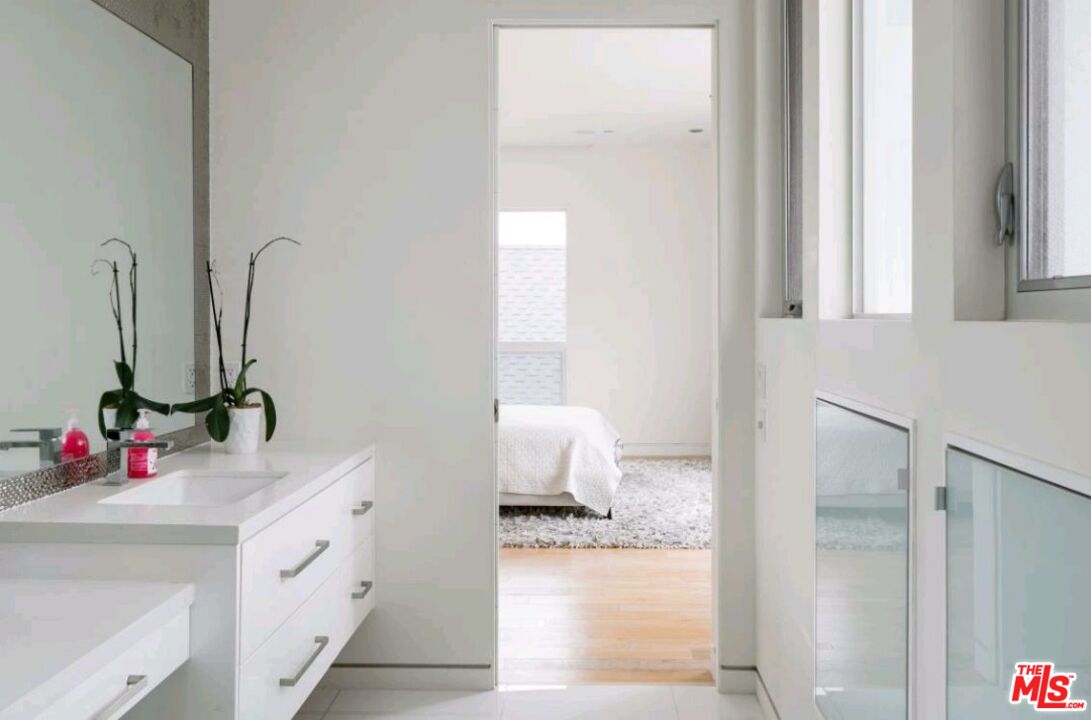 6620 West 5th Street Los Angeles, CA 90048 - Photo 21 of 34 a bathroom with a sink vanity and a mirror