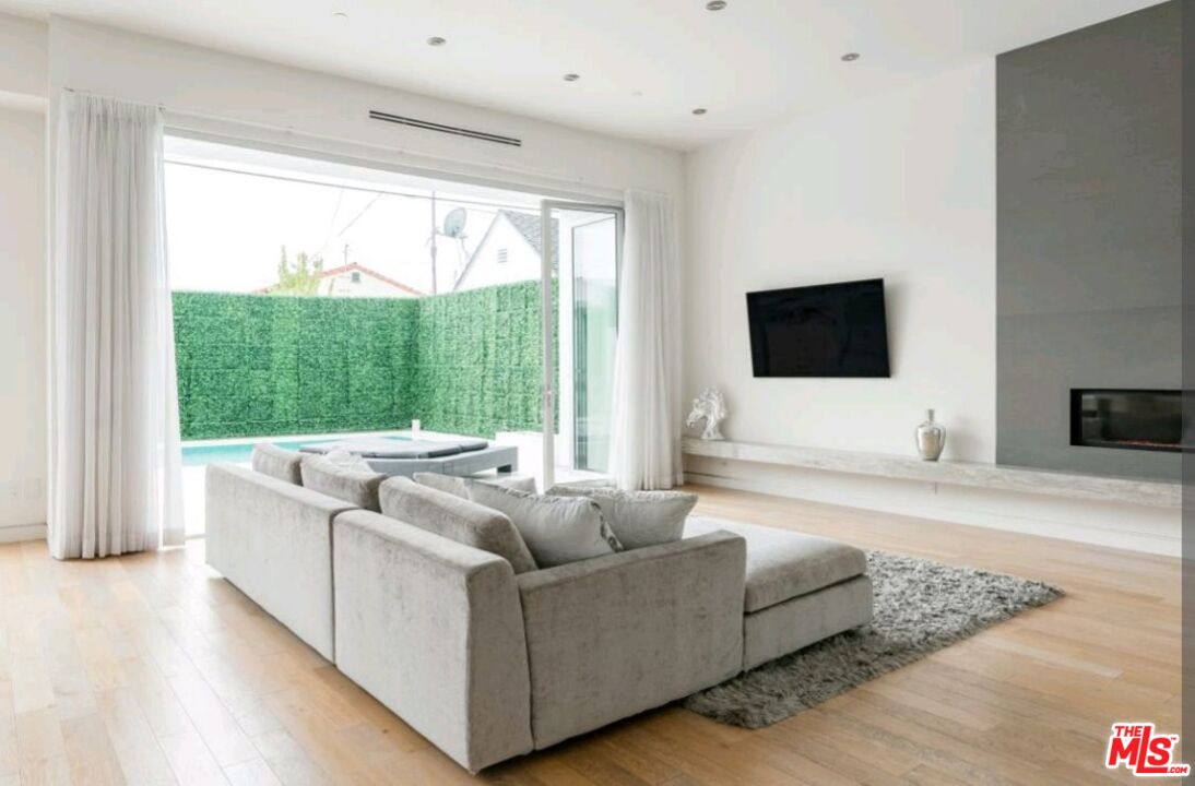 6620 West 5th Street Los Angeles, CA 90048 - Photo 4 of 34 a living room with furniture and a flat screen tv