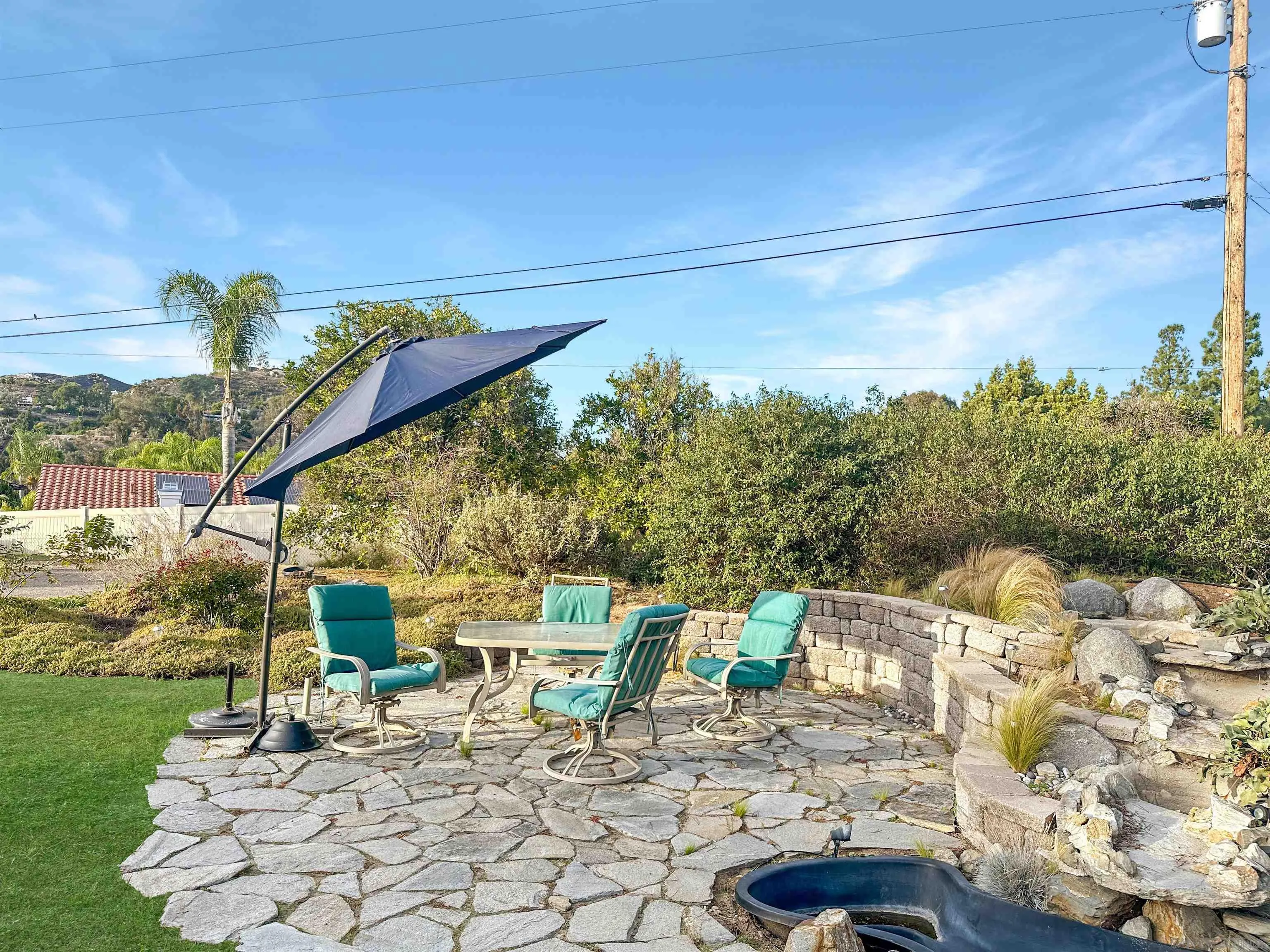 1704 Mudge Lane Escondido, CA 92026 - Photo 3 of 13 a view of a patio with a table and chairs under an umbrella