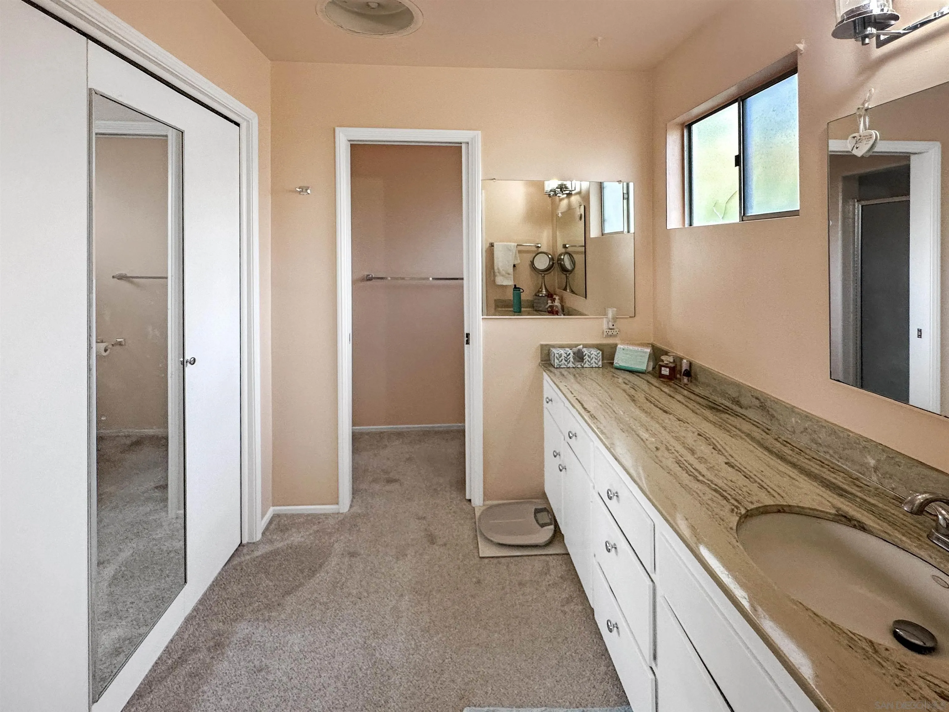 1704 Mudge Lane Escondido, CA 92026 - Photo 10 of 13 a spacious bathroom with a granite countertop sink and a mirror