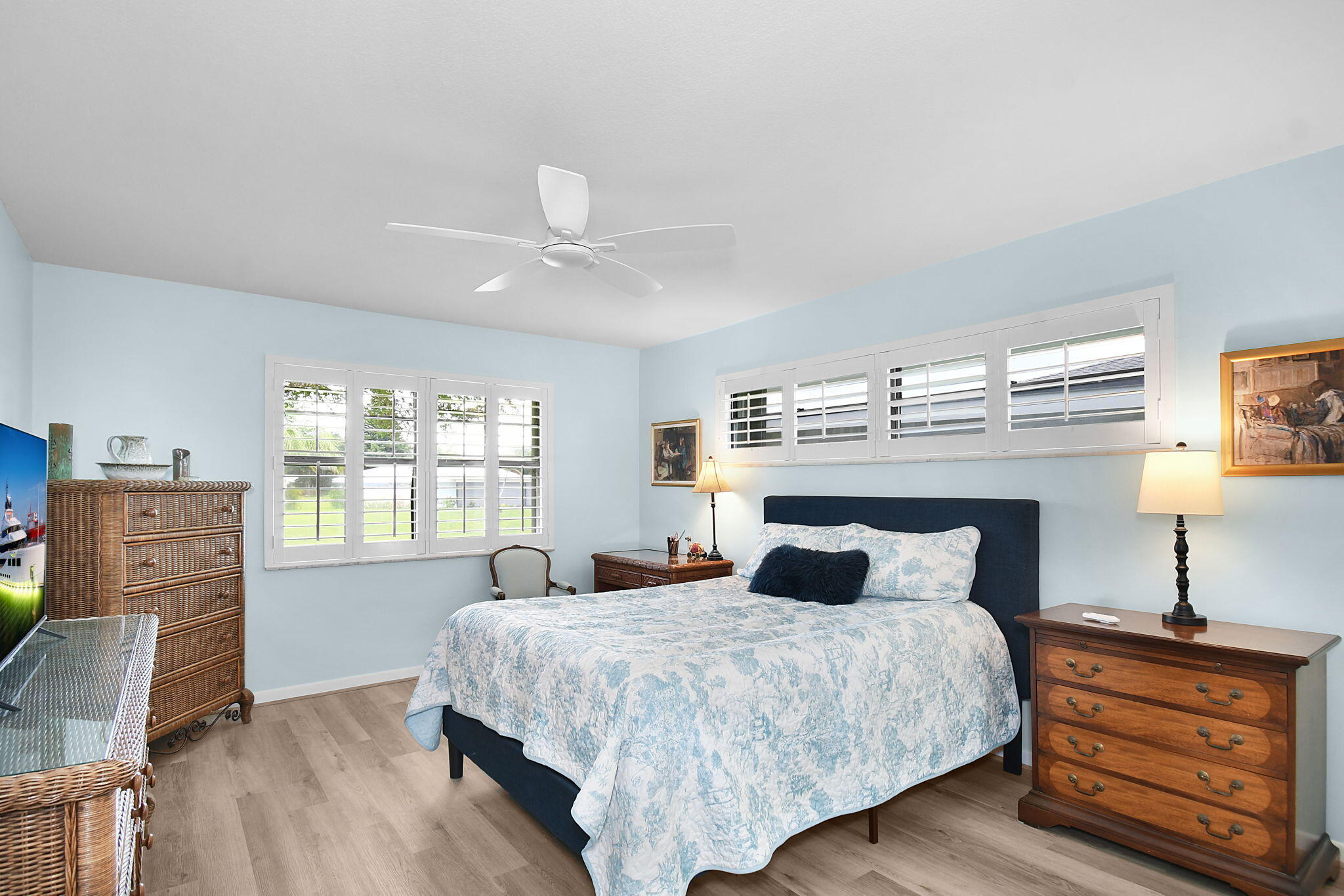 5251 Southeast Sea Island Way Stuart, FL 34997 - Photo 18 of 68 a bedroom with a large bed and wooden floor