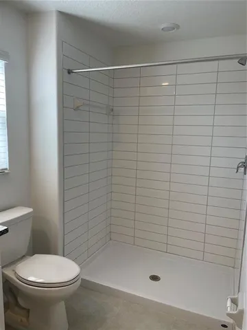 a bathroom with a shower and a toilet