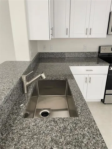 a kitchen with cabinets stainless steel appliances and a counter space