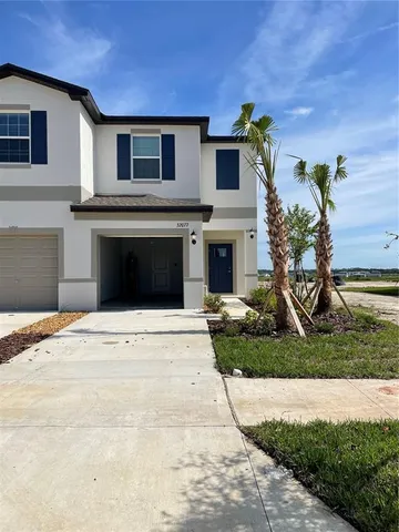 a front view of a house with a yard and garage
