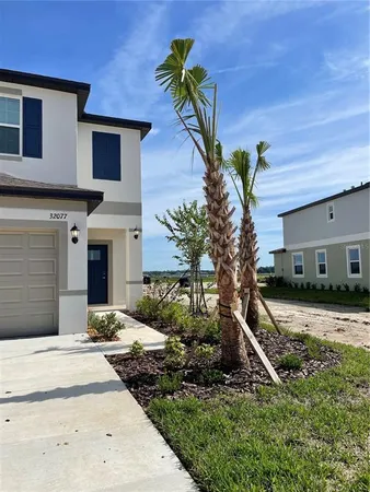 a house that has a tree in front of it
