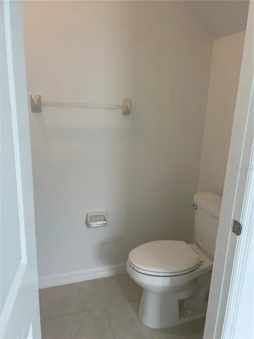 a white toilet sitting next to a shower