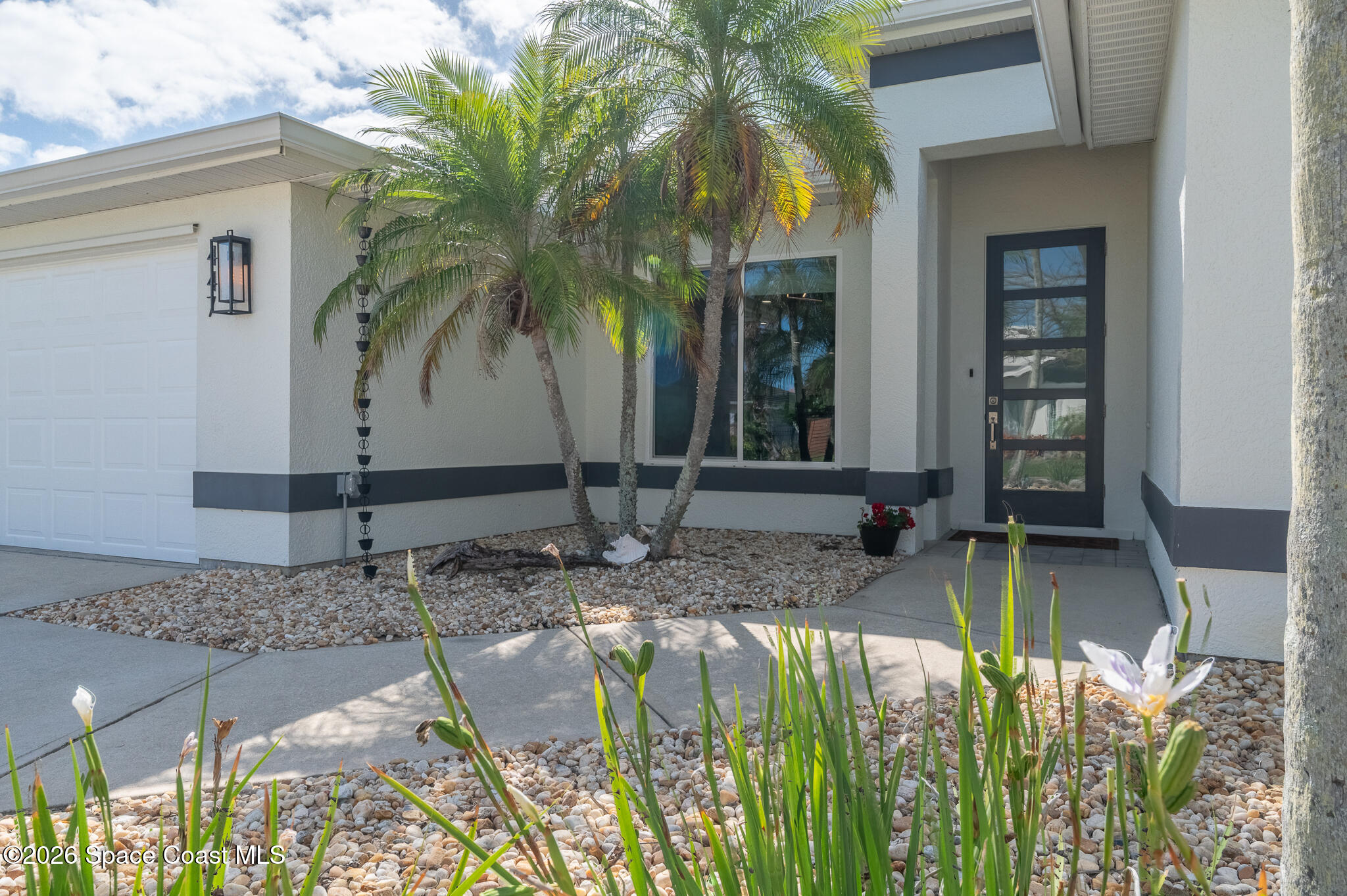 447 Sandy Key Melbourne Beach, FL 32951 - Photo 1 of 94 a view of front door and potted plants