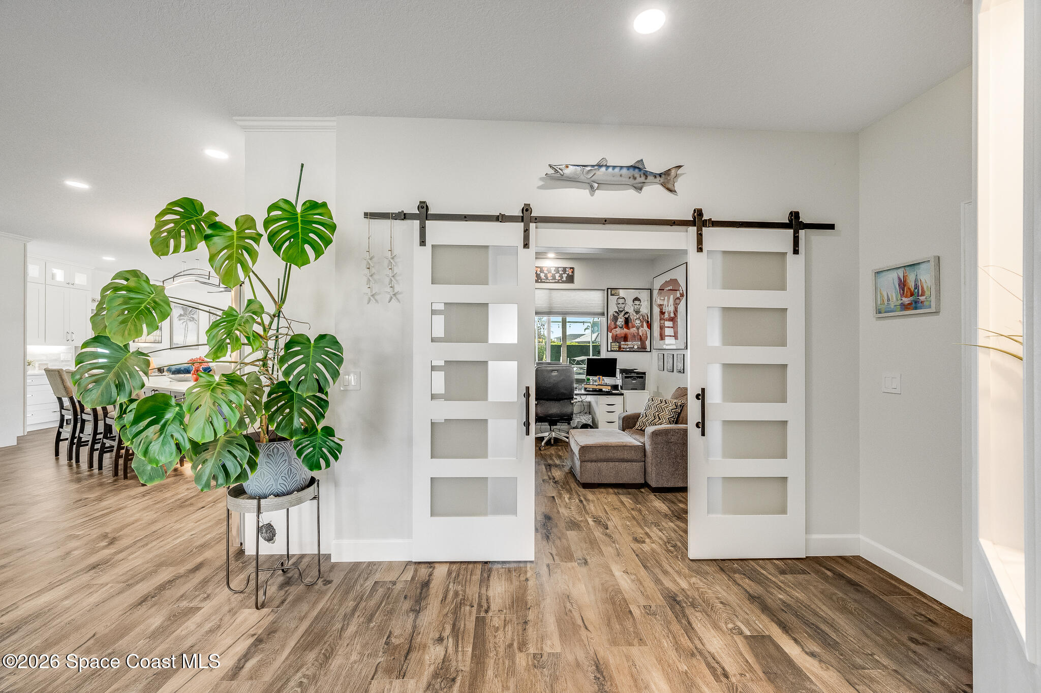 447 Sandy Key Melbourne Beach, FL 32951 - Photo 11 of 94 a white vase with flowers on wooden floor